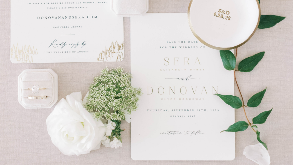A white wedding invitation with wording about saving the wedding date.